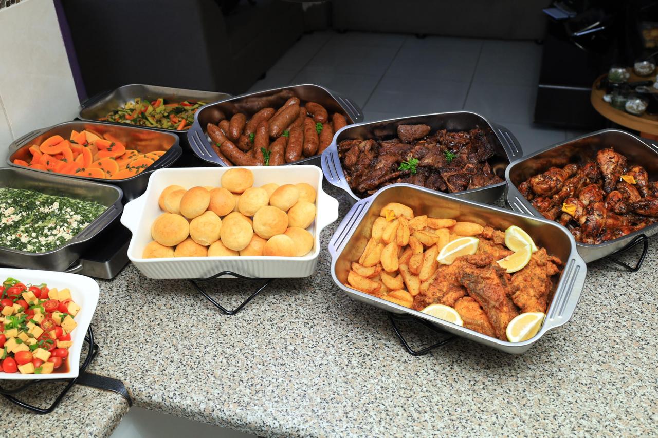 South African buffet spread with meat, rolls and vegetables